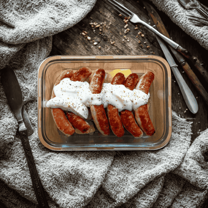 Salchichas de pollo con salsa de queso y patata panadera